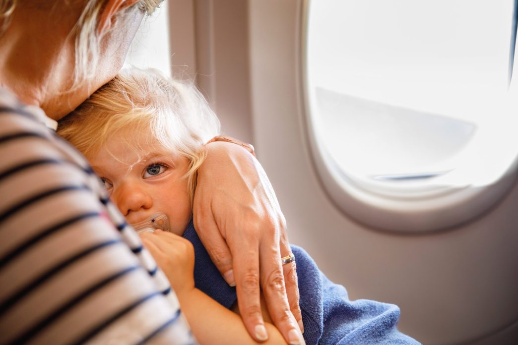 Helping child sleep on a plane