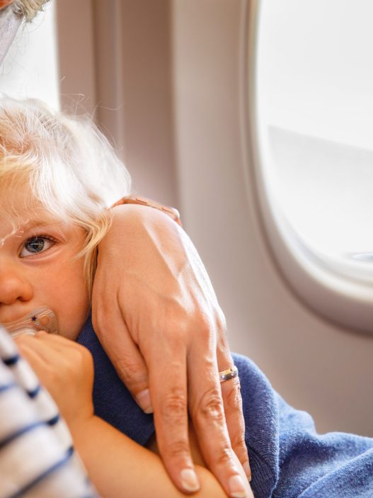Helping child sleep on a plane